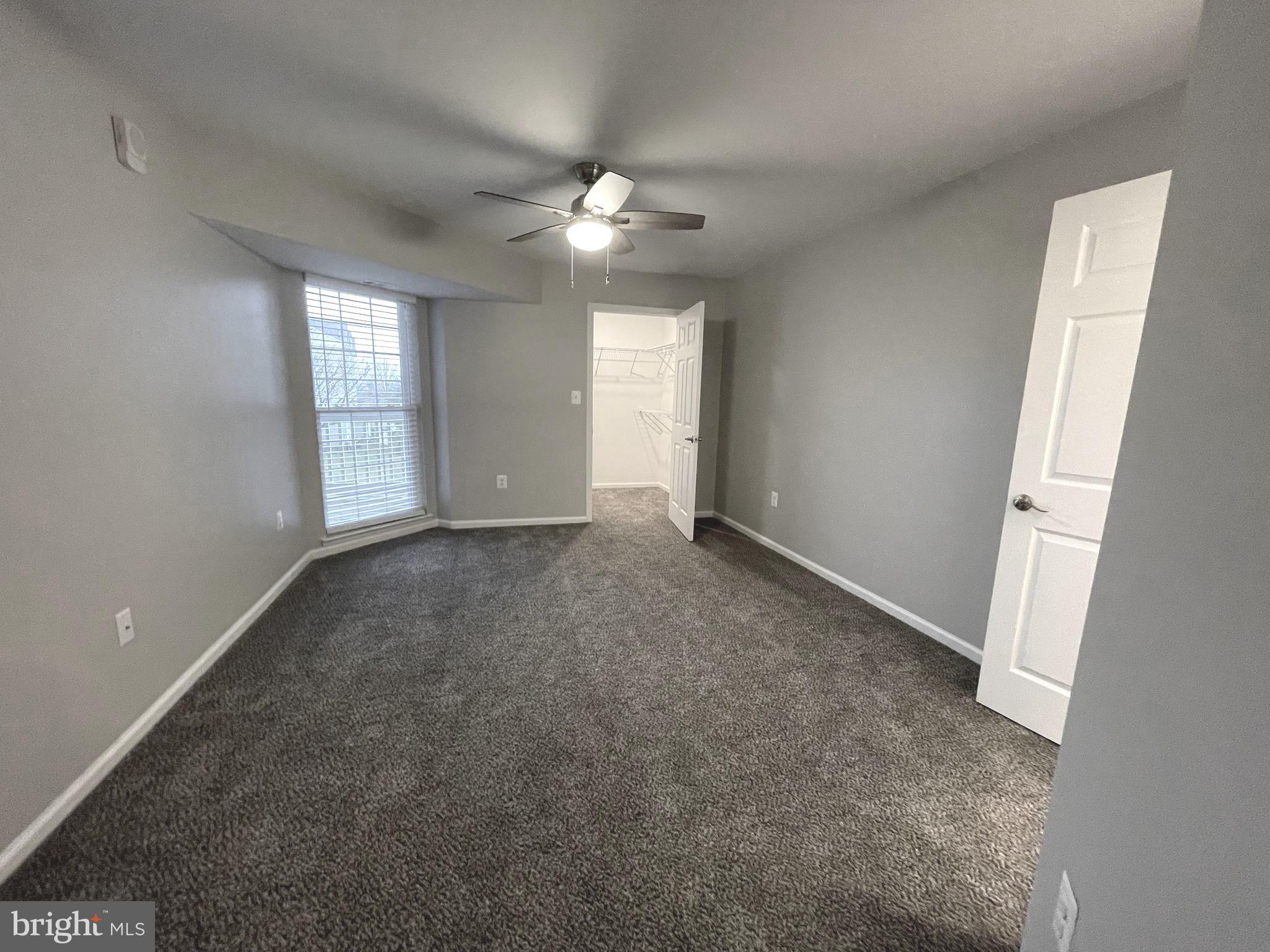 2507 Shelley Circle, Unit 42B Frederick, MD 21702 - Photo 14 of 30 an empty room with windows and chandelier fan