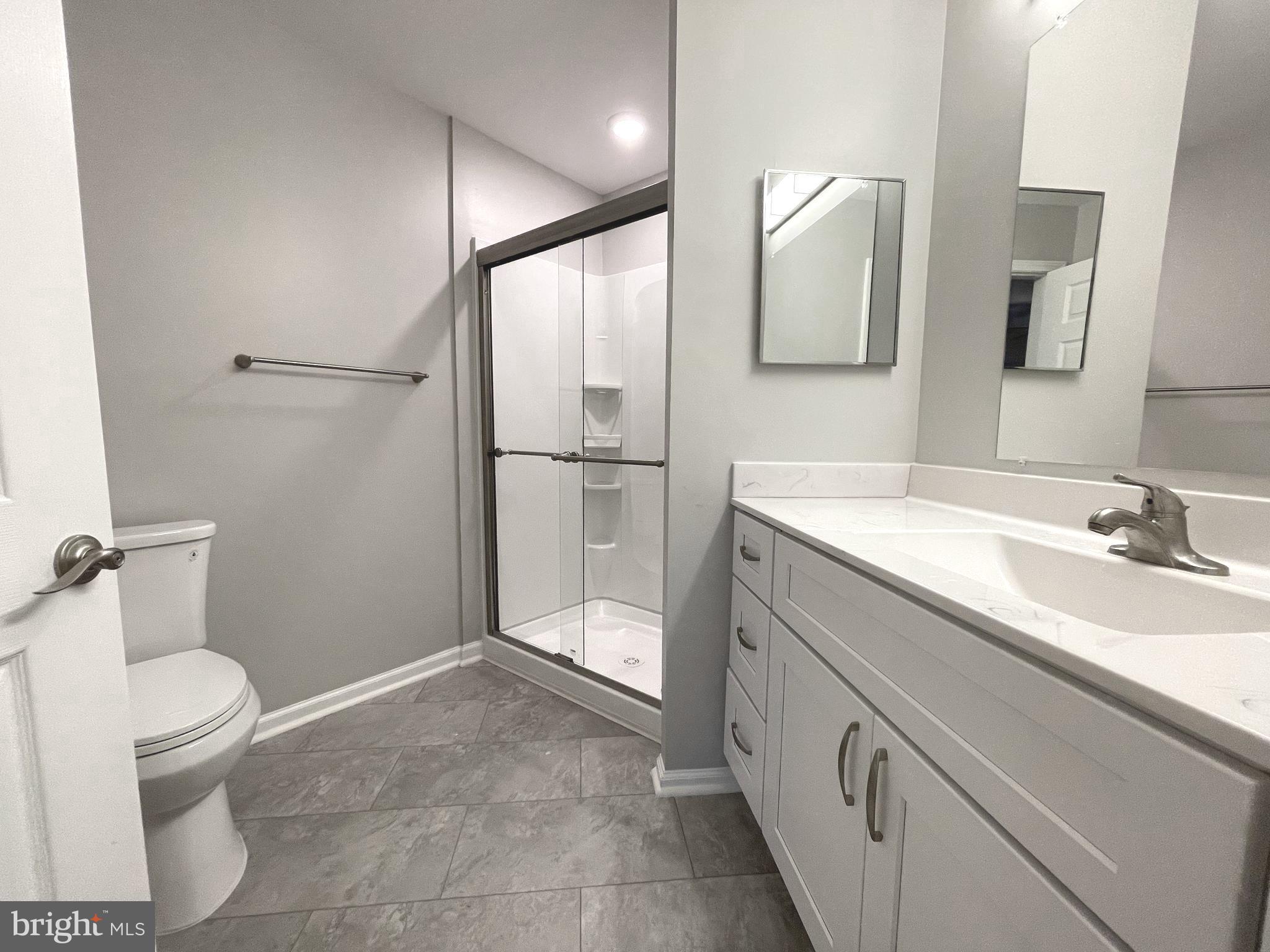 2507 Shelley Circle, Unit 42B Frederick, MD 21702 - Photo 18 of 30 a bathroom with a sink a toilet and mirror