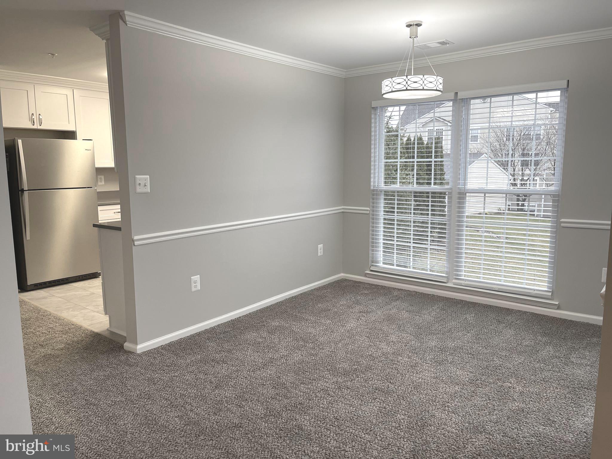 2507 Shelley Circle, Unit 42B Frederick, MD 21702 - Photo 20 of 30 a view of empty room with windows and refrigerator