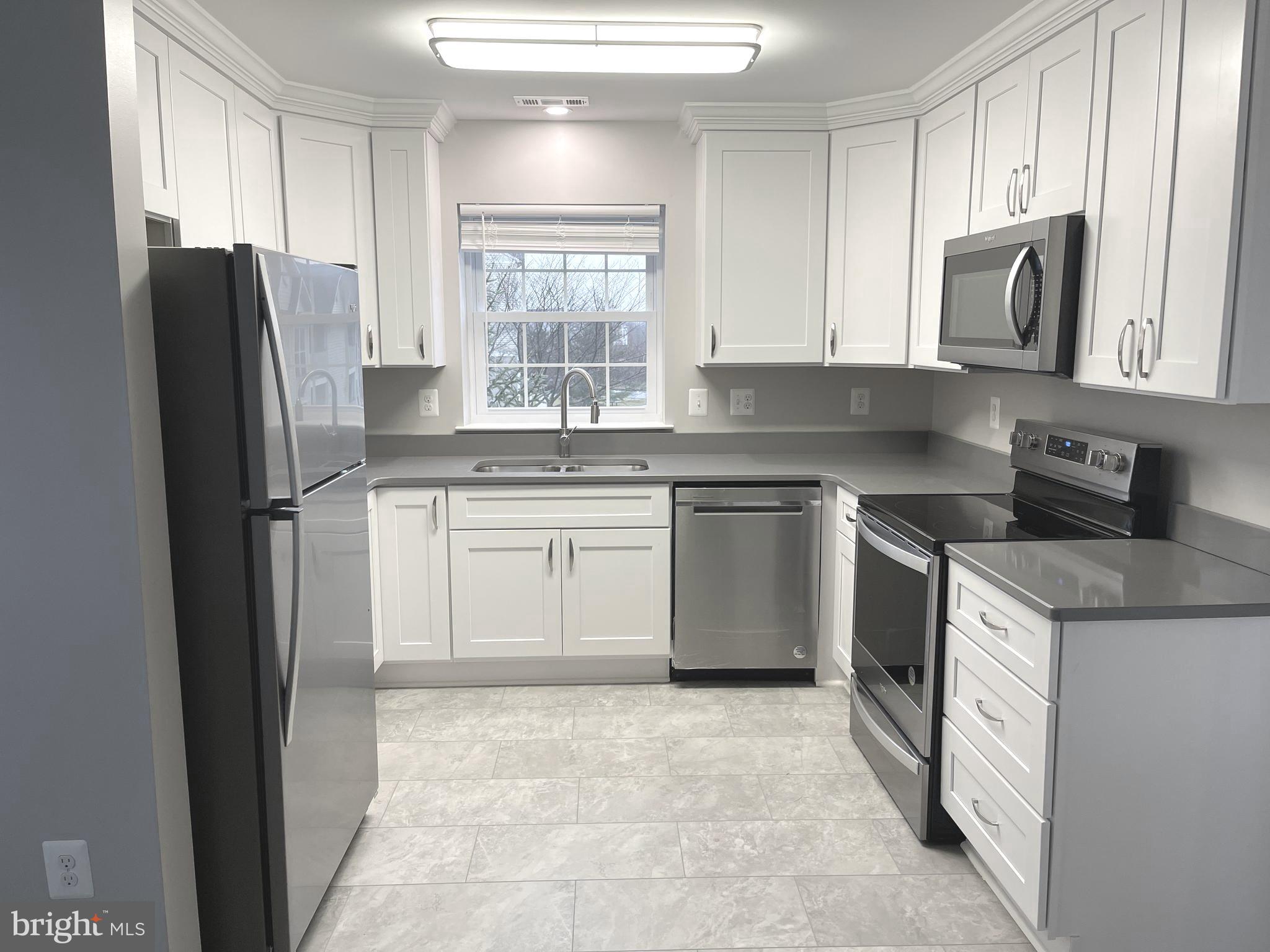 2507 Shelley Circle, Unit 42B Frederick, MD 21702 - Photo 21 of 30 a kitchen with stainless steel appliances granite countertop a refrigerator sink and stove