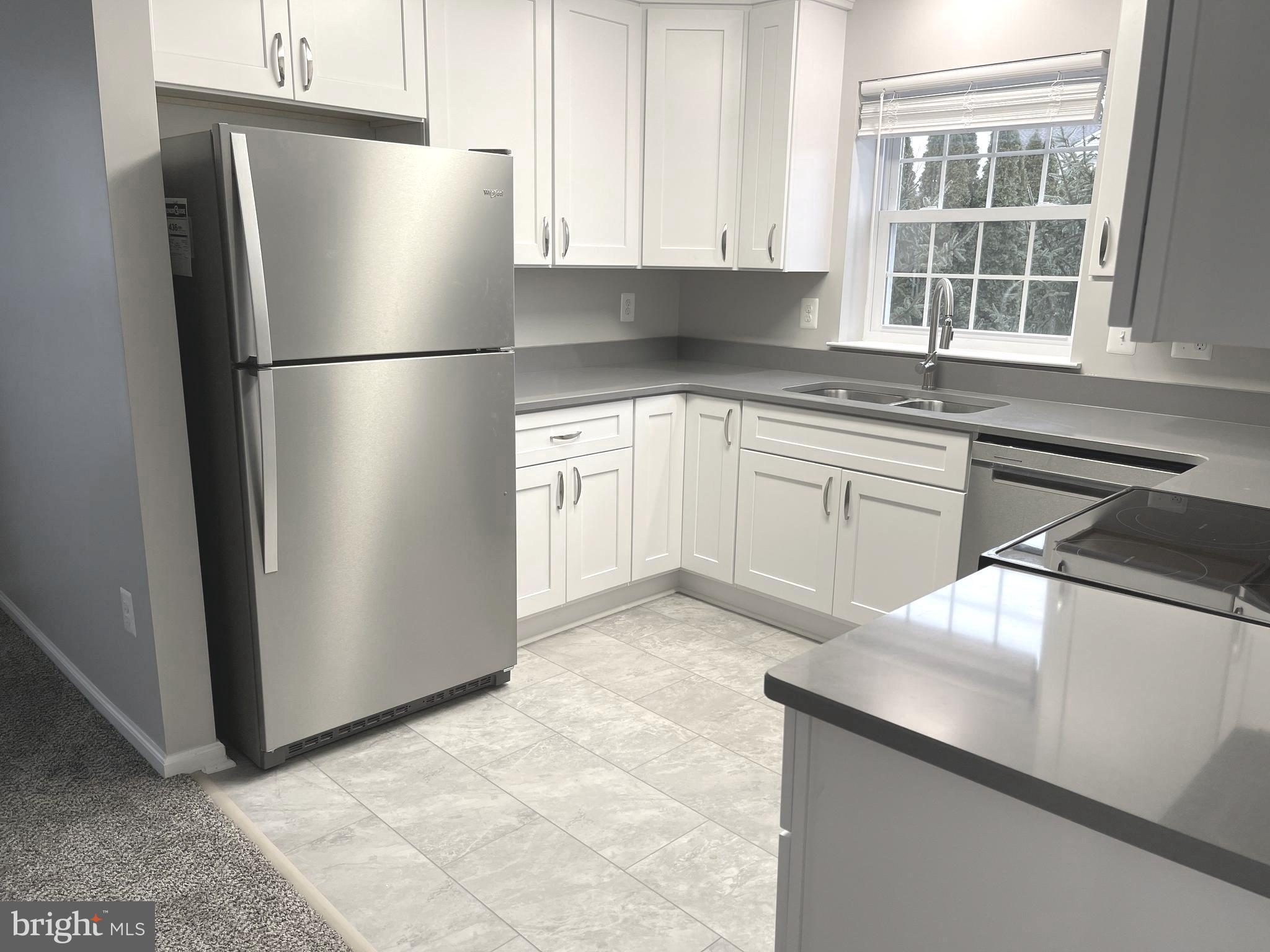 2507 Shelley Circle, Unit 42B Frederick, MD 21702 - Photo 22 of 30 a kitchen with a refrigerator sink and cabinets