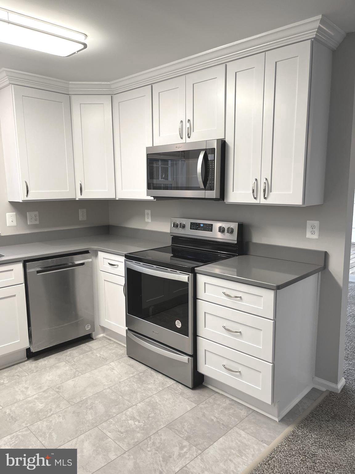 2507 Shelley Circle, Unit 42B Frederick, MD 21702 - Photo 23 of 30 a kitchen with granite countertop white cabinets and stainless steel appliances