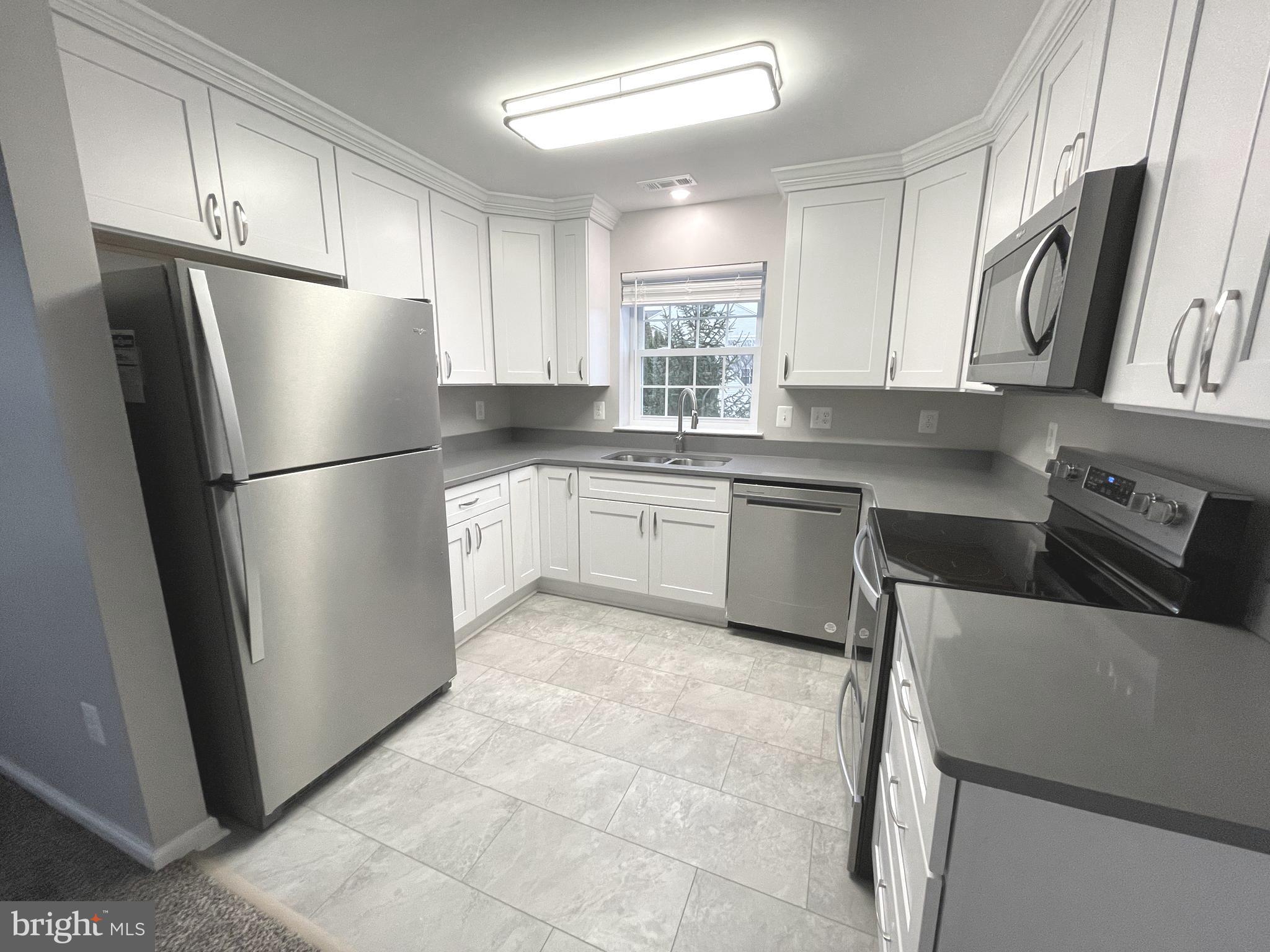 2507 Shelley Circle, Unit 42B Frederick, MD 21702 - Photo 24 of 30 a kitchen with stainless steel appliances granite countertop a refrigerator sink and cabinets