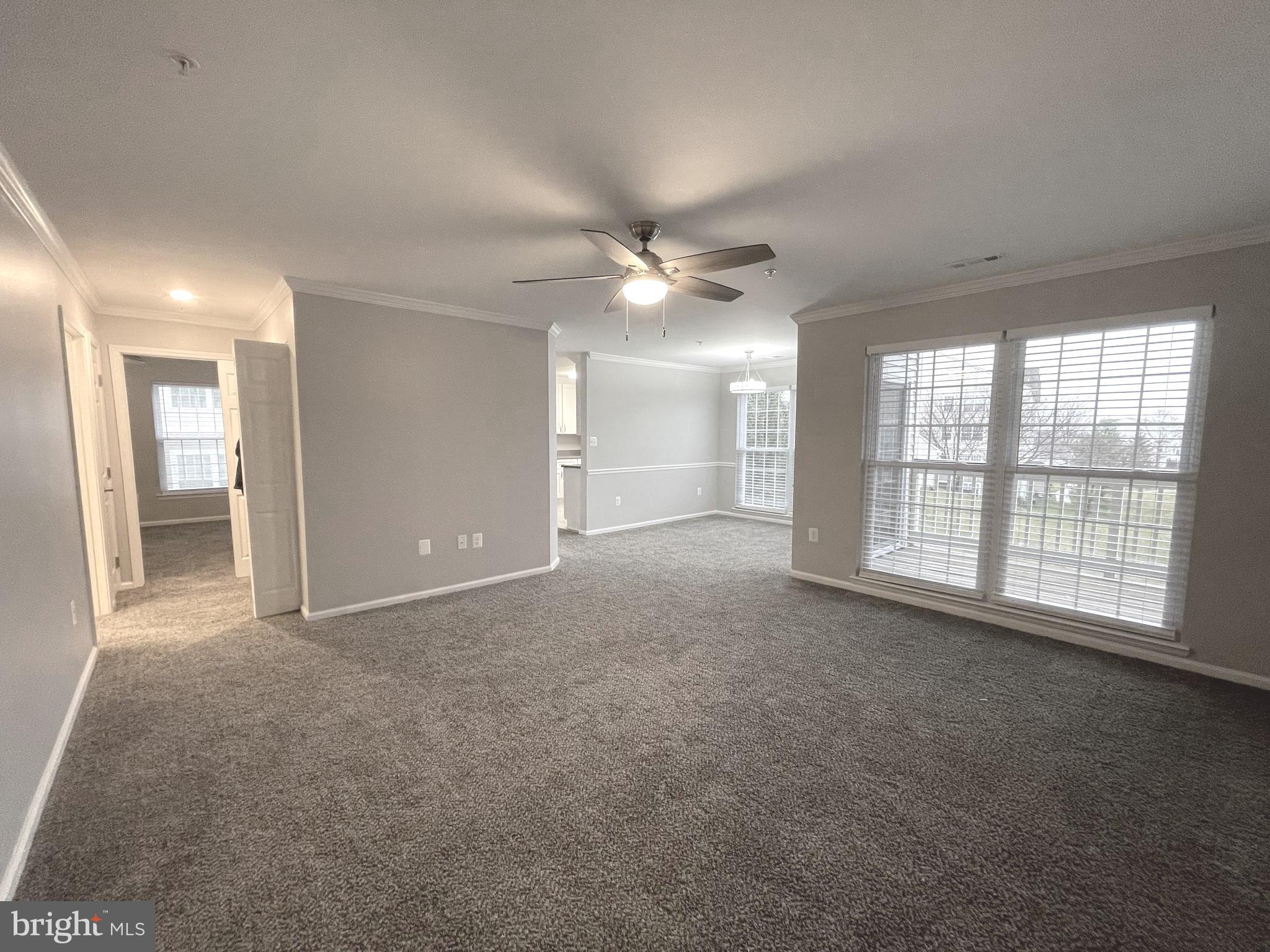2507 Shelley Circle, Unit 42B Frederick, MD 21702 - Photo 3 of 30 an empty room with windows and ceiling fan