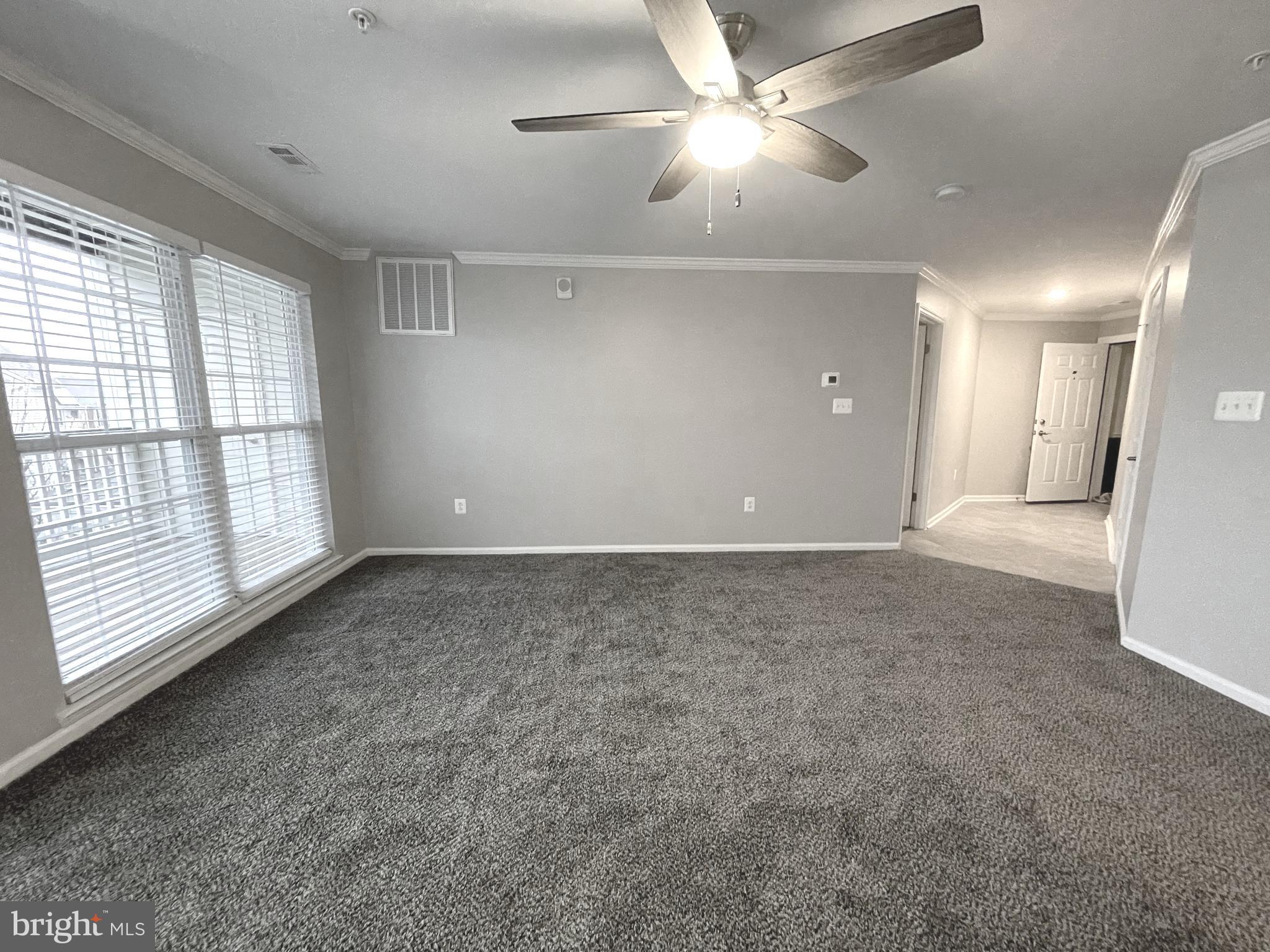 2507 Shelley Circle, Unit 42B Frederick, MD 21702 - Photo 5 of 30 an empty room with chandelier fan and windows