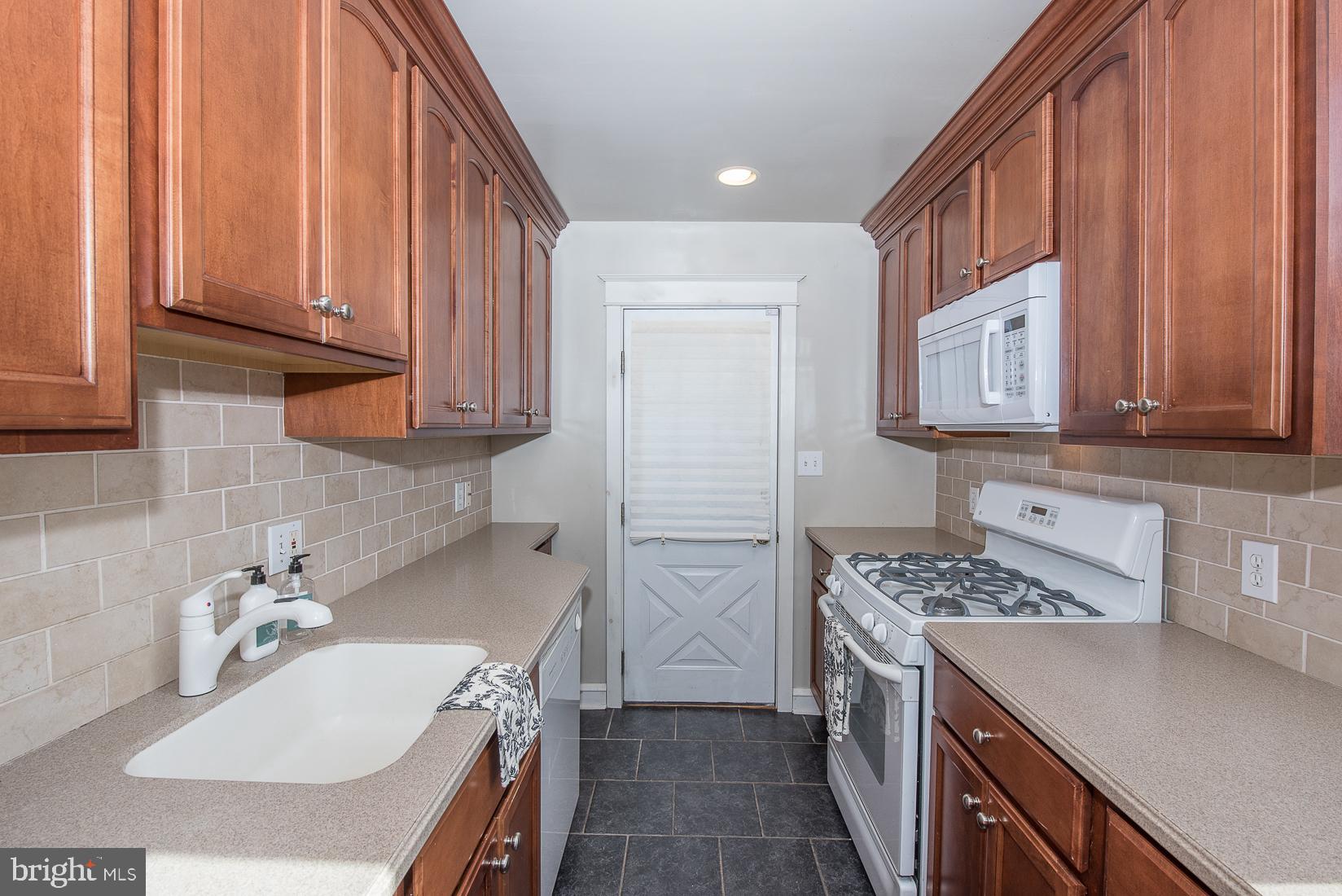 623 Kenilworth Road Ardmore, PA 19003 - Photo 12 of 22 Cherry cabinetry and Corian Counters