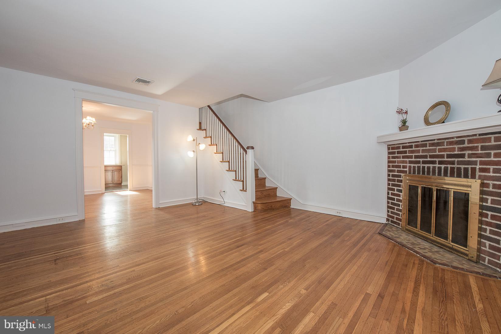 623 Kenilworth Road Ardmore, PA 19003 - Photo 4 of 22 Living Room with brick fireplace that opens to DR
