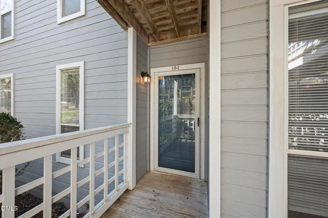 a view of a porch with wooden floor and a window