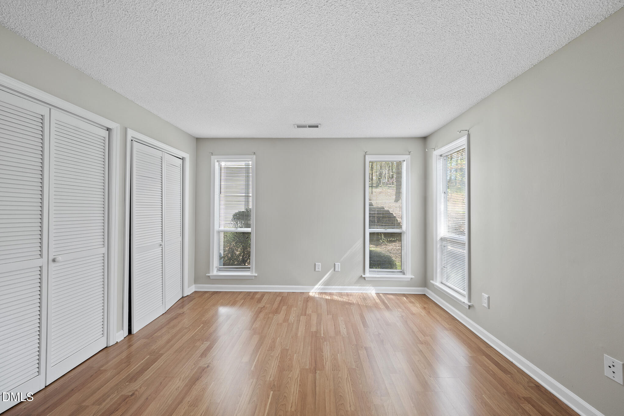 4601 Timbermill Court, Unit 104 Raleigh, NC 27612 - Photo 12 of 24 wooden floor in an empty room with a window