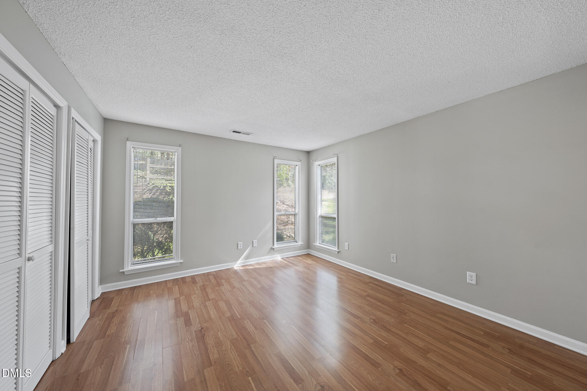 4601 Timbermill Court, Unit 104 Raleigh, NC 27612 - Photo 13 of 24 a view of an empty room with wooden floor and a window
