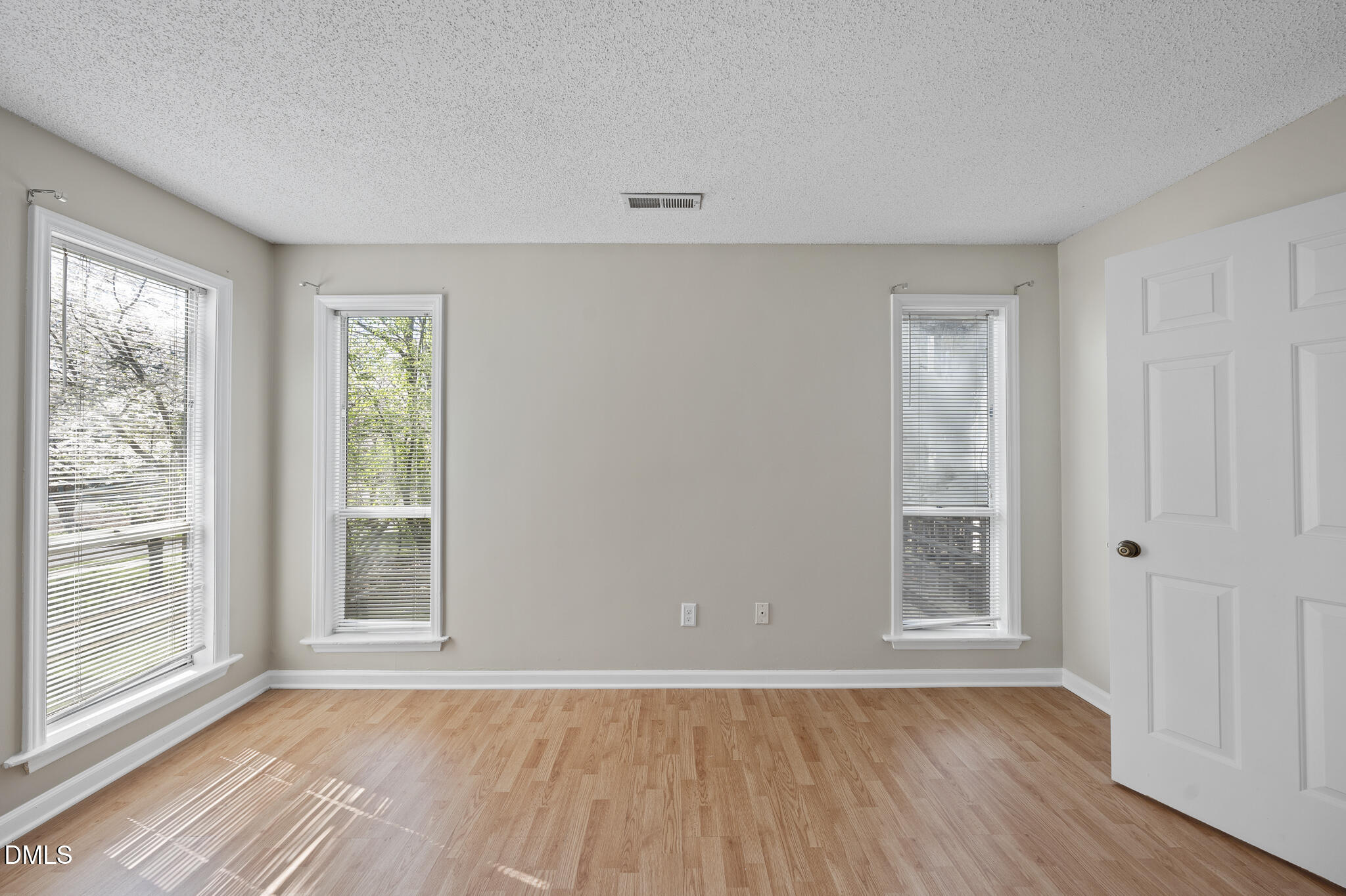 4601 Timbermill Court, Unit 104 Raleigh, NC 27612 - Photo 17 of 24 a view of an empty room with wooden floor and a window