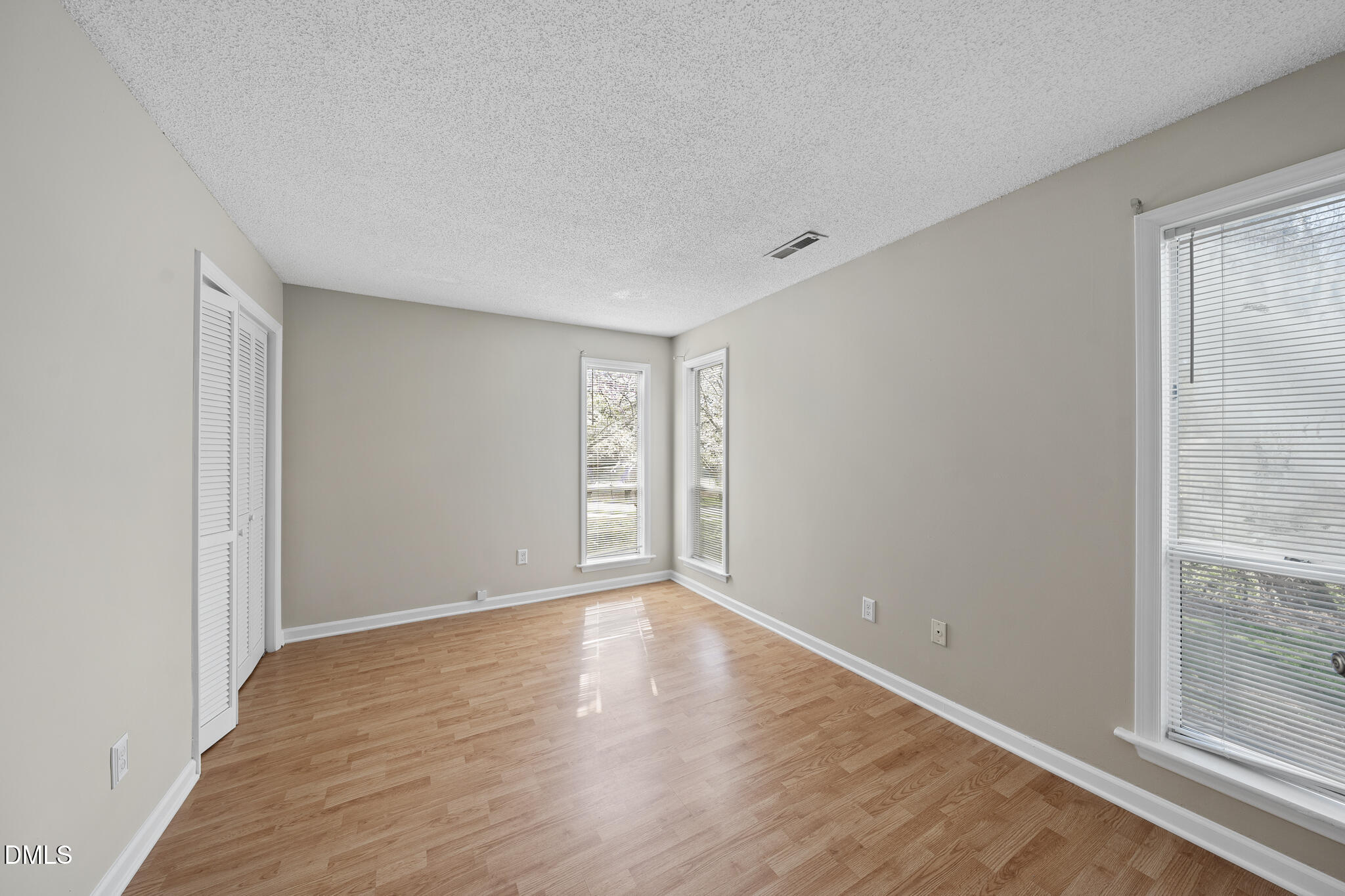 4601 Timbermill Court, Unit 104 Raleigh, NC 27612 - Photo 18 of 24 a view of an empty room with wooden floor and a window