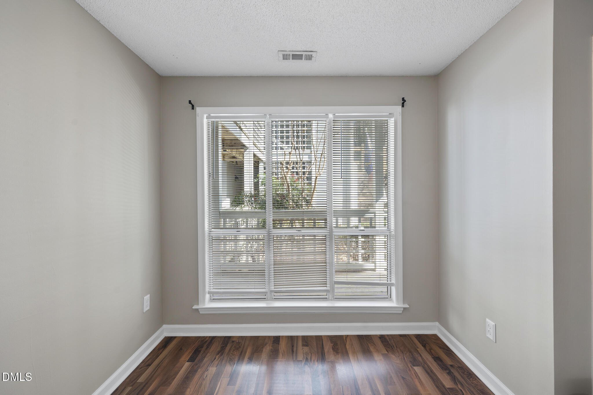 4601 Timbermill Court, Unit 104 Raleigh, NC 27612 - Photo 19 of 24 an empty room with wooden floor and windows