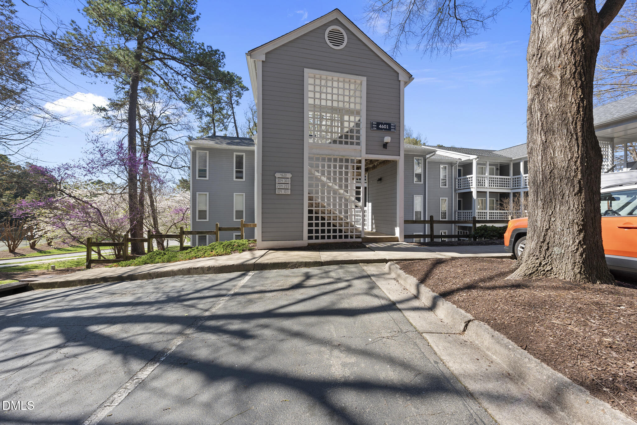 4601 Timbermill Court, Unit 104 Raleigh, NC 27612 - Photo 3 of 24 a front view of a house with a yard
