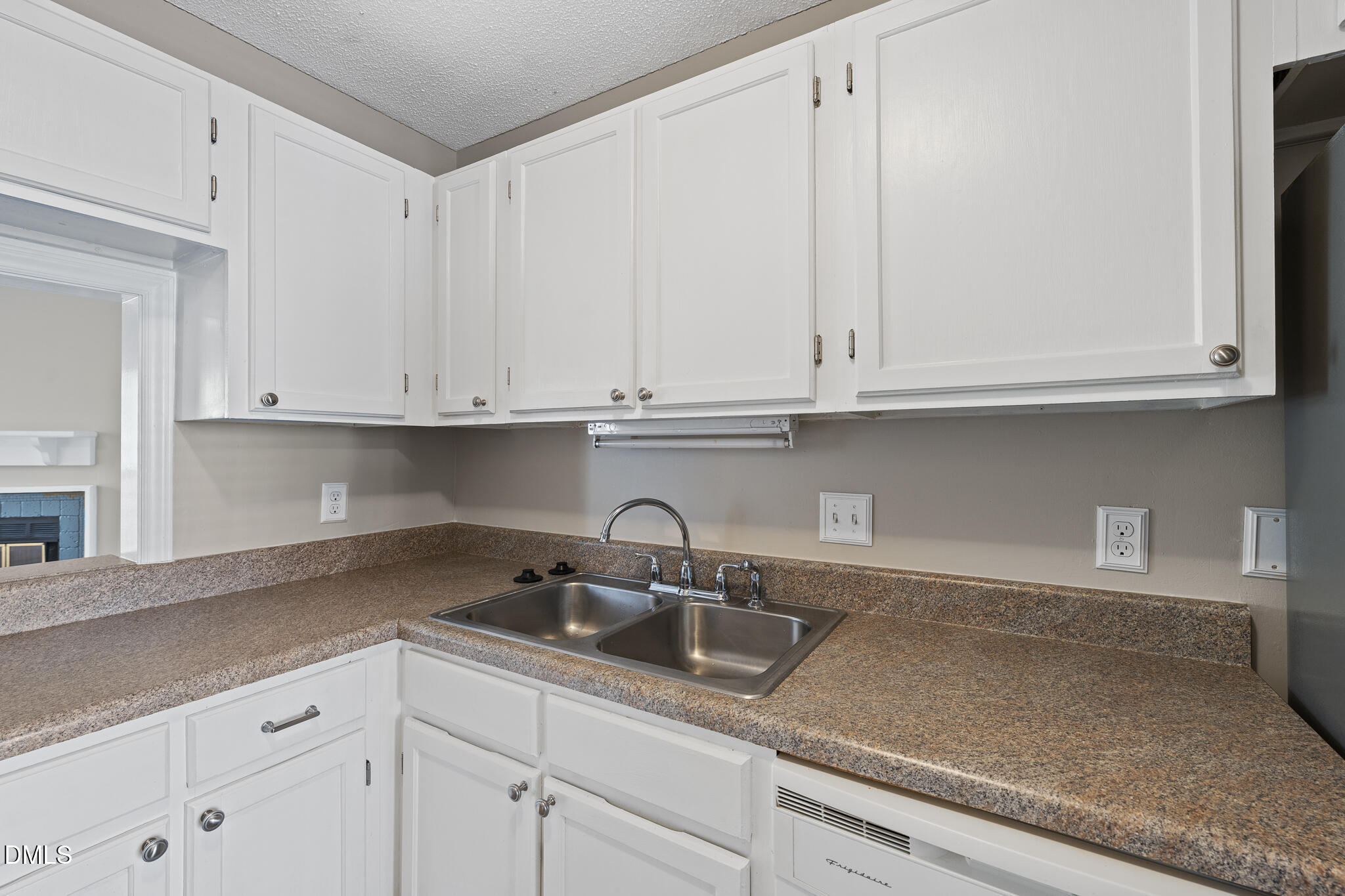4601 Timbermill Court, Unit 104 Raleigh, NC 27612 - Photo 4 of 24 a kitchen with granite countertop white cabinets and a sink
