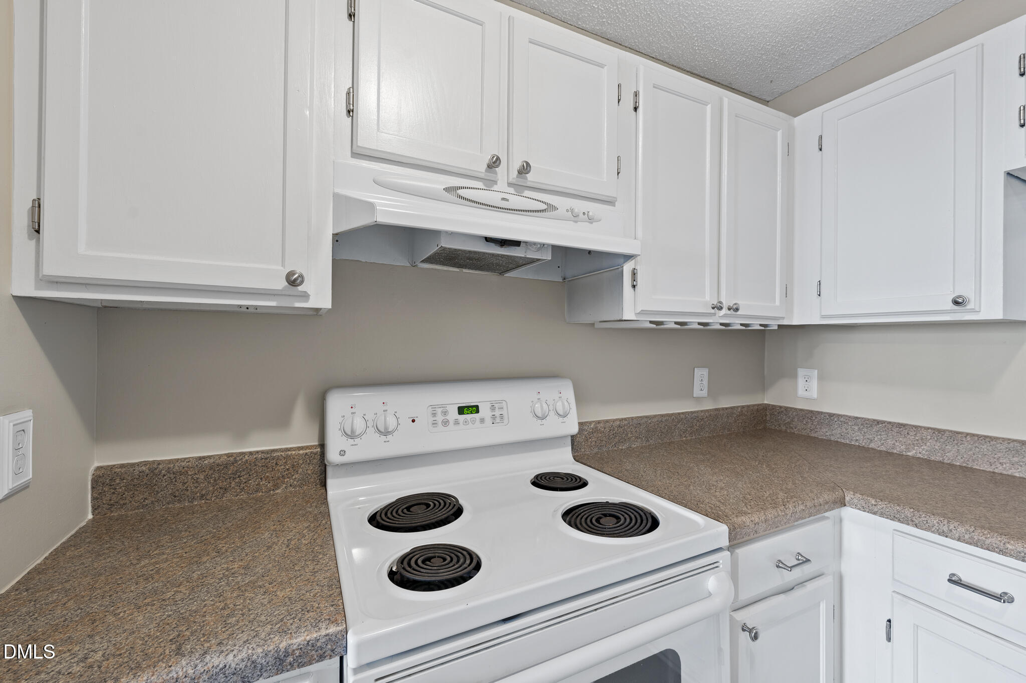 4601 Timbermill Court, Unit 104 Raleigh, NC 27612 - Photo 6 of 24 a kitchen with white cabinets and white appliances