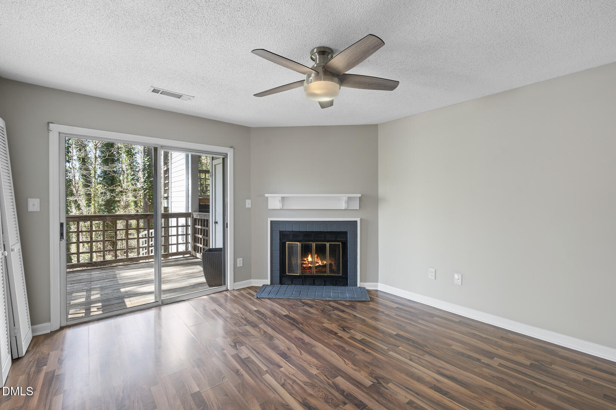 4601 Timbermill Court, Unit 104 Raleigh, NC 27612 - Photo 7 of 24 wooden floor fireplace and windows in an empty room