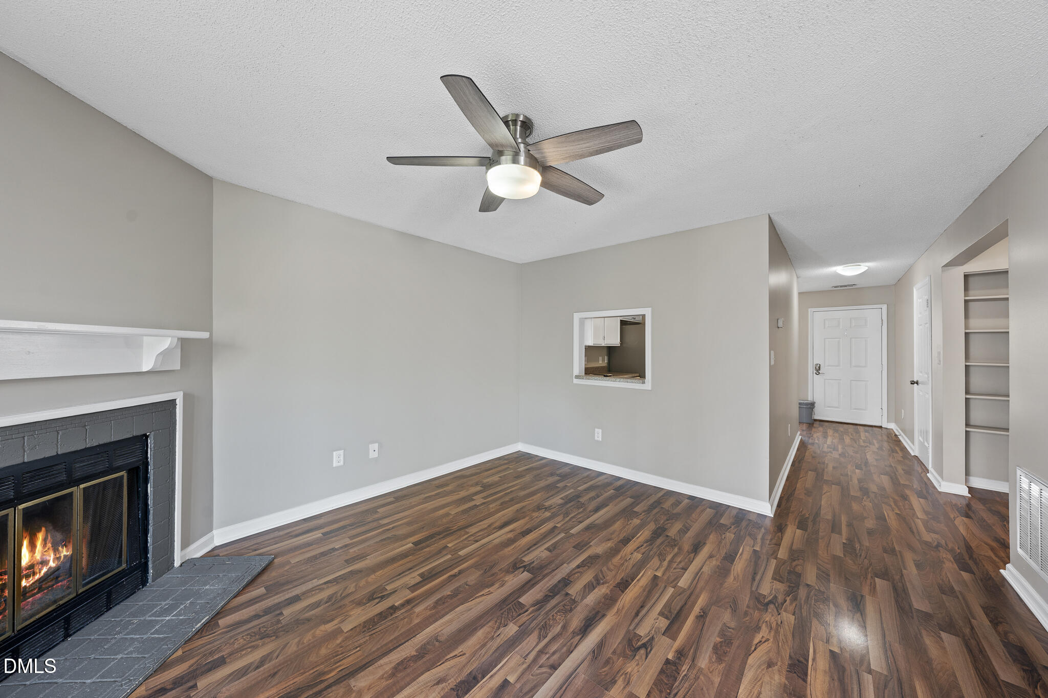 4601 Timbermill Court, Unit 104 Raleigh, NC 27612 - Photo 8 of 24 a view of empty room with wooden floor and fan