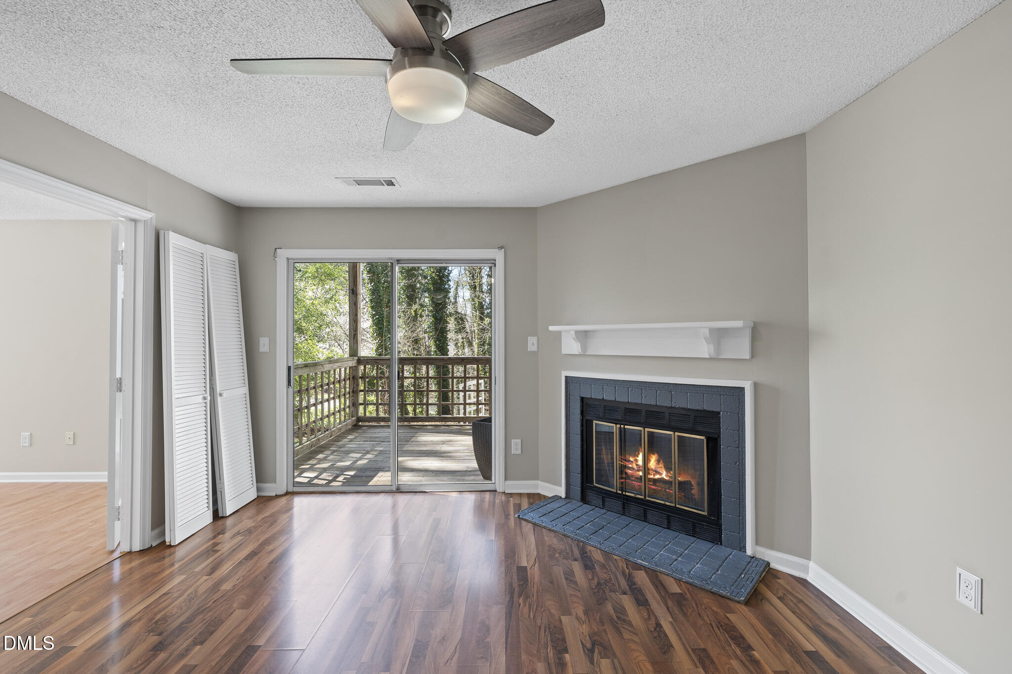 4601 Timbermill Court, Unit 104 Raleigh, NC 27612 - Photo 9 of 24 an empty room with wooden floor fireplace and windows