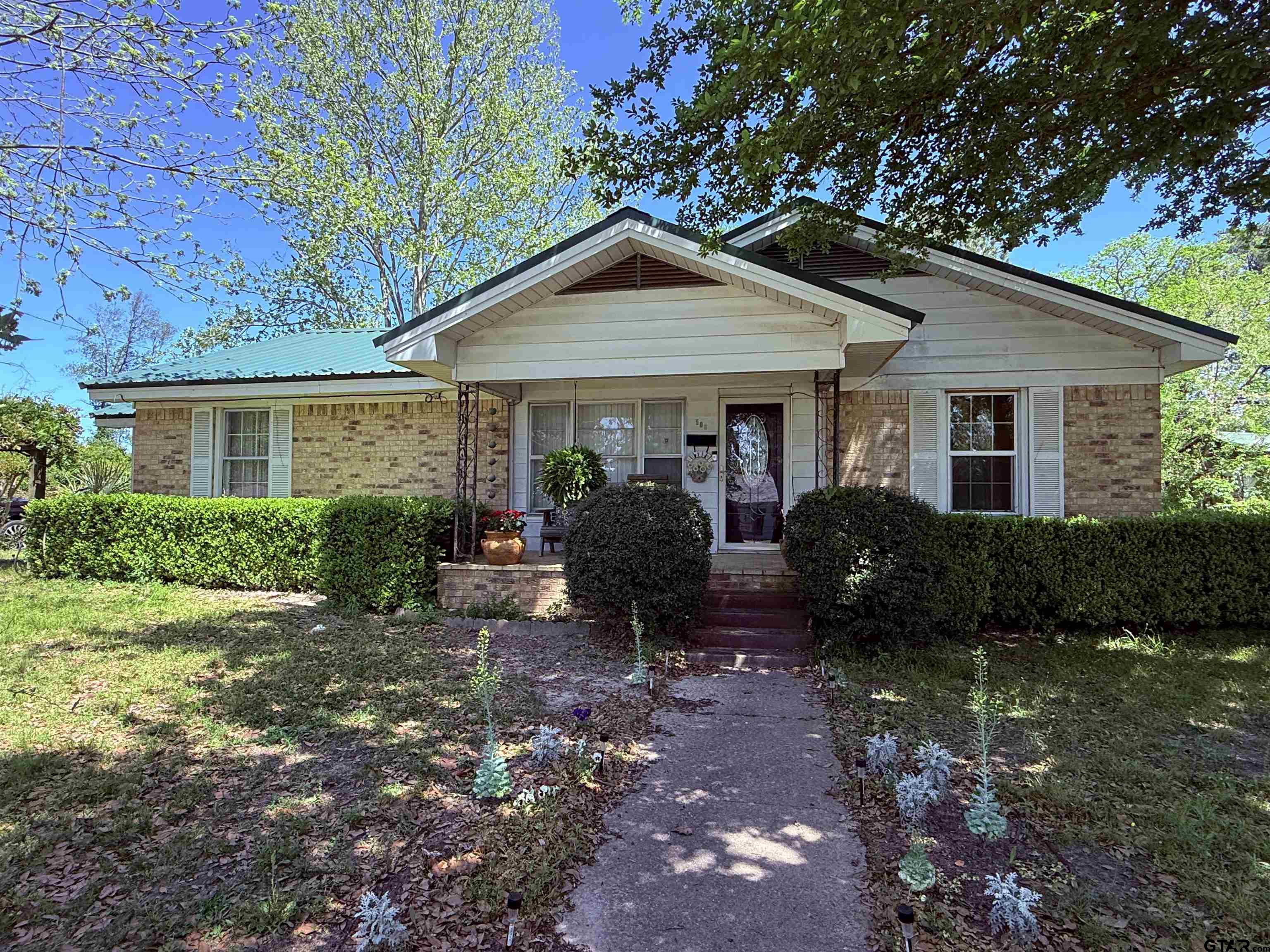 a view of a house with yard and chairs