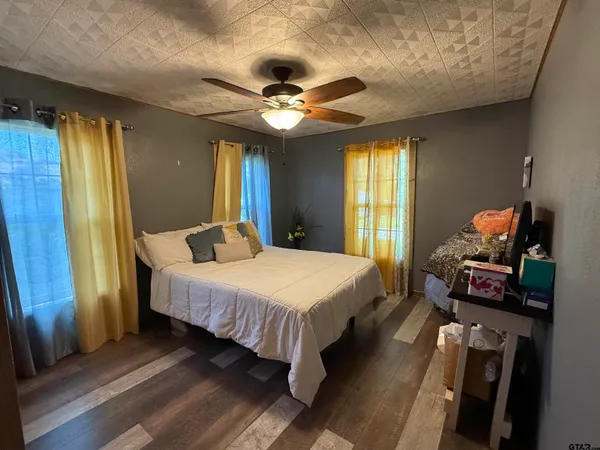 a bed sitting in a bedroom next to a window