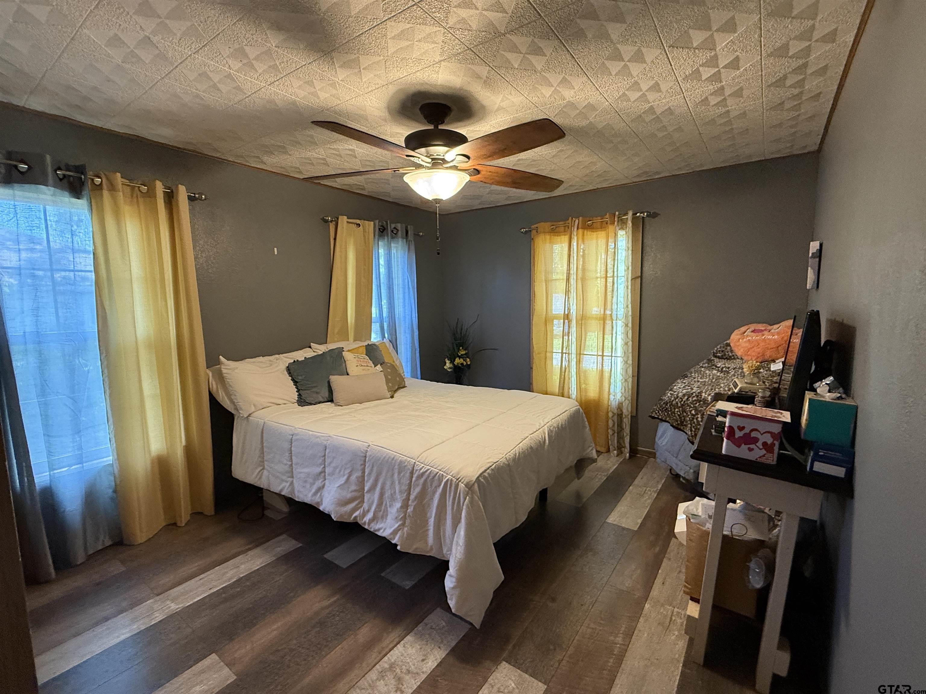 508 Whippoorwill Street Henderson, TX 75652 - Photo 13 of 24 a bed sitting in a bedroom next to a window