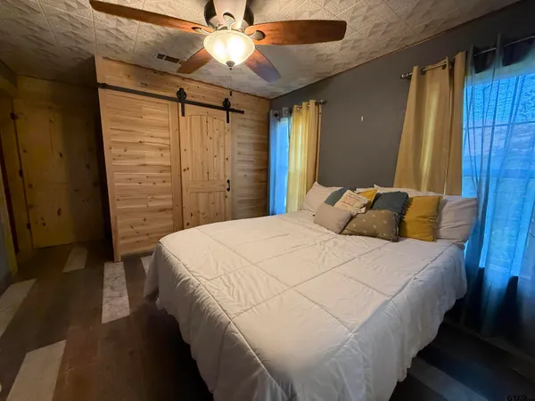 a bedroom with a bed and a chandelier