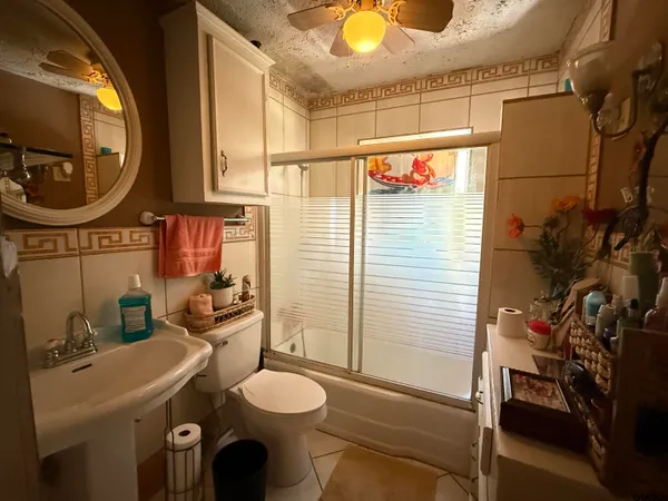 a bathroom with a toilet a sink and a mirror