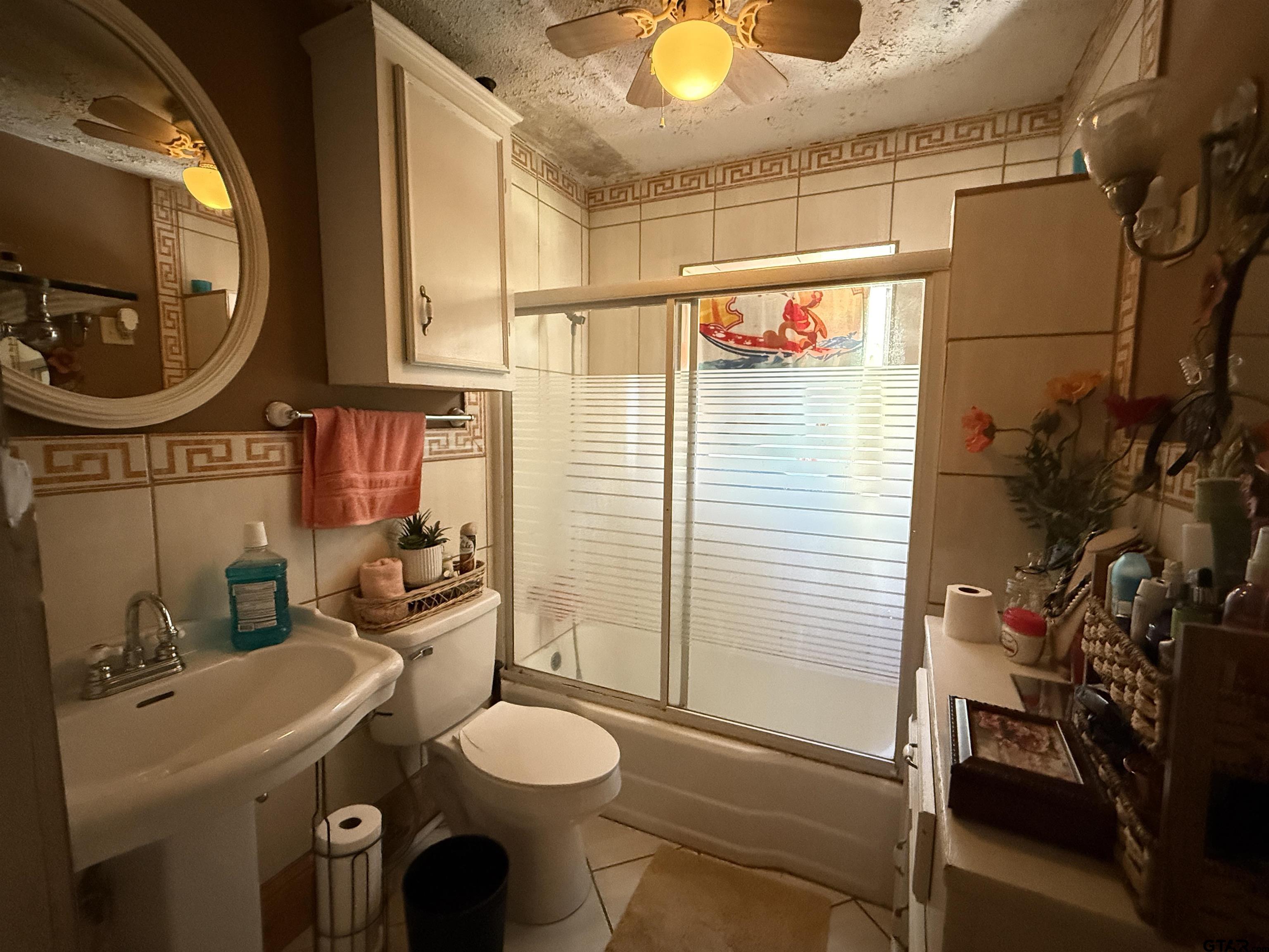 508 Whippoorwill Street Henderson, TX 75652 - Photo 16 of 24 a bathroom with a toilet a sink and a mirror