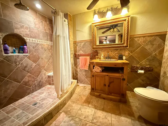 a bathroom with a sink toilet and shower
