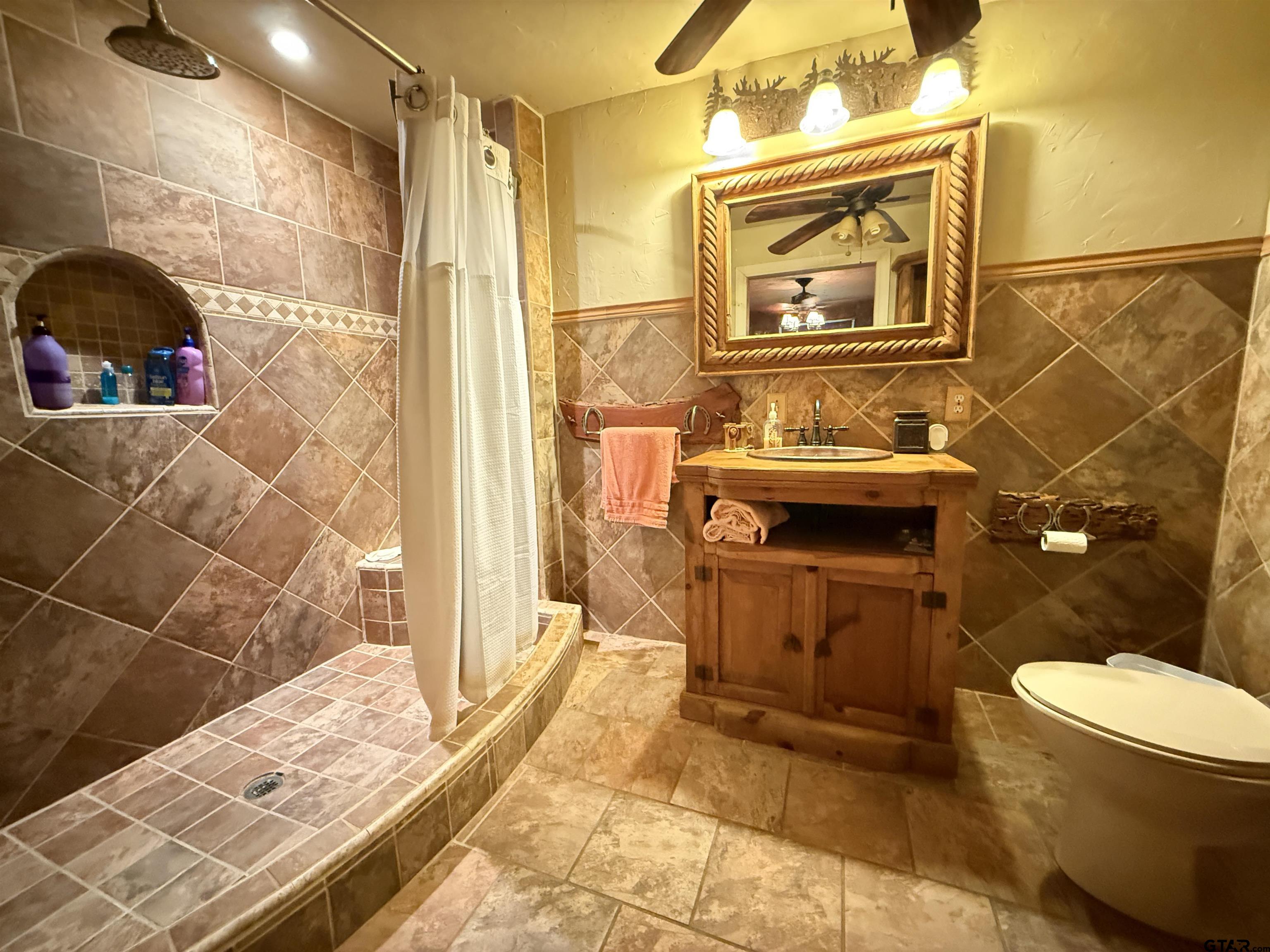 508 Whippoorwill Street Henderson, TX 75652 - Photo 17 of 24 a bathroom with a sink toilet and shower