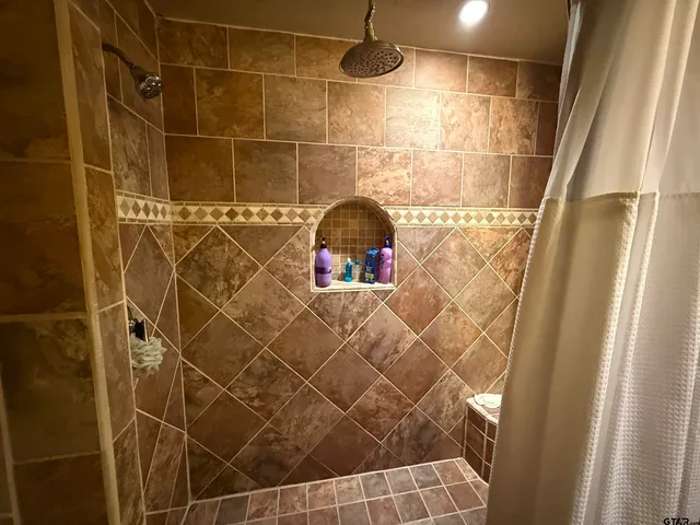 a bathroom with a shower and a glass door shower