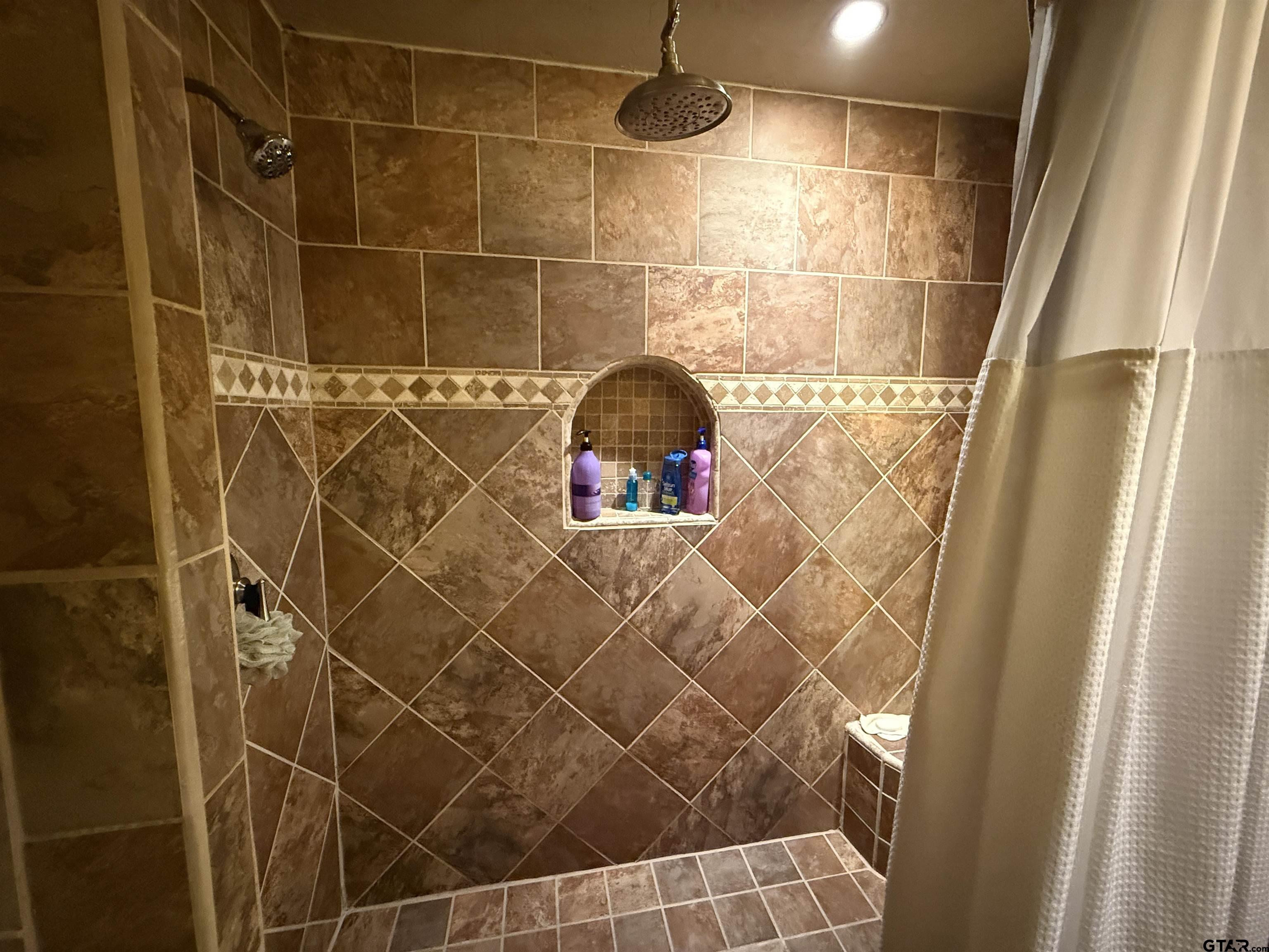 508 Whippoorwill Street Henderson, TX 75652 - Photo 18 of 24 a bathroom with a shower and a glass door shower