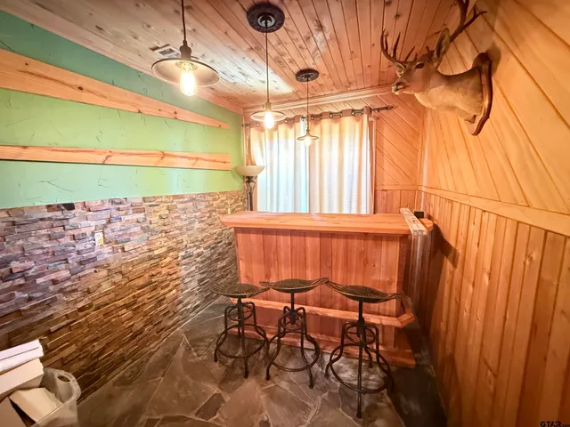 a view of a room with table and chairs