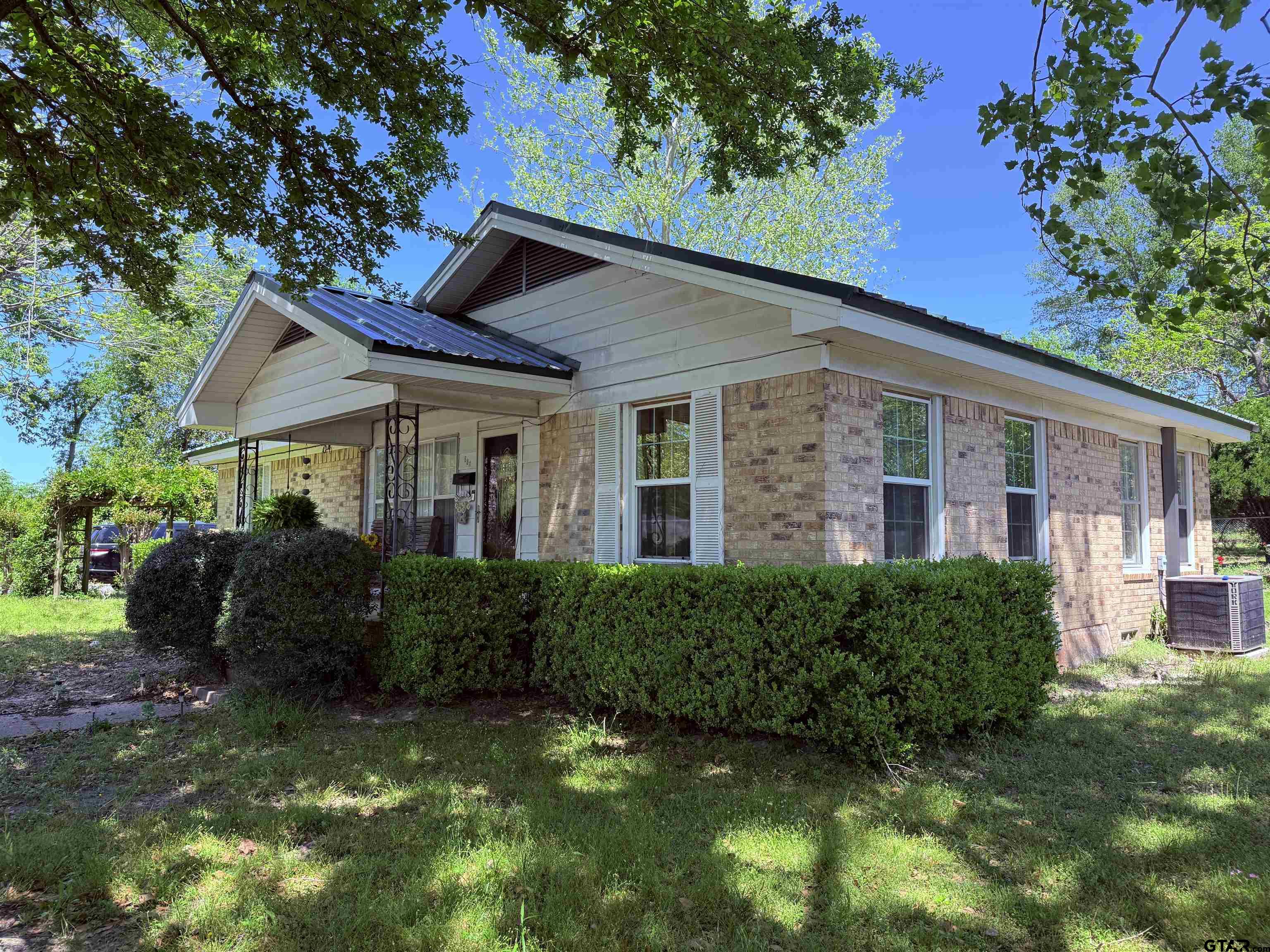 508 Whippoorwill Street Henderson, TX 75652 - Photo 2 of 24 a view of a house with brick walls and a yard with plants