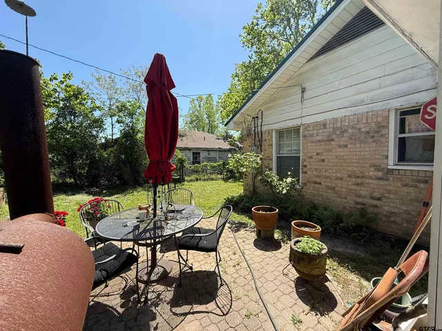 a view of a patio with table and chairs potted plants with wooden floor