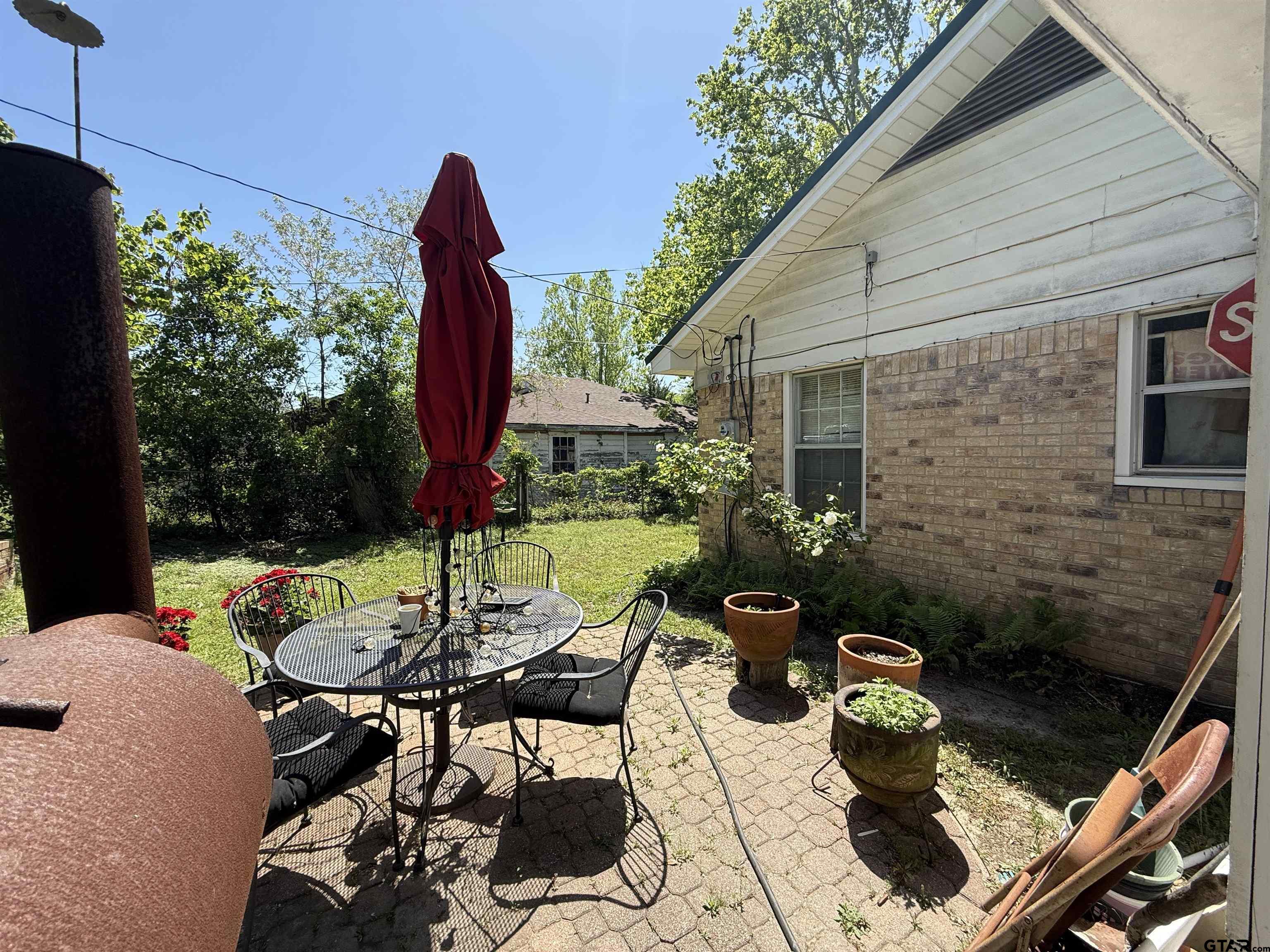 508 Whippoorwill Street Henderson, TX 75652 - Photo 21 of 24 a view of a patio with table and chairs potted plants with wooden floor