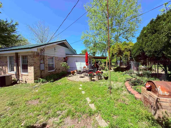 a view of a house with backyard porch and sitting area