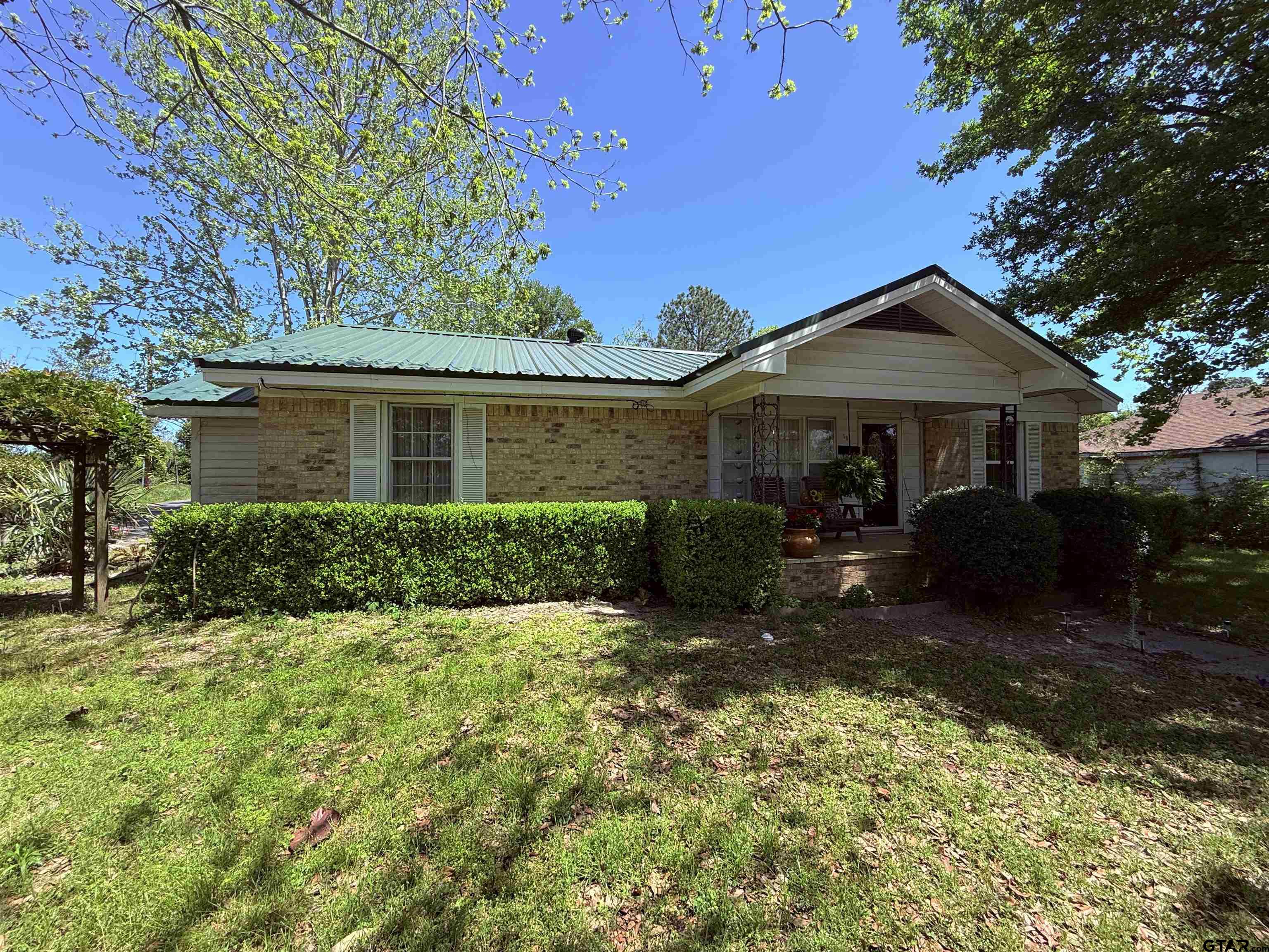 508 Whippoorwill Street Henderson, TX 75652 - Photo 4 of 24 a front view of a house with garden