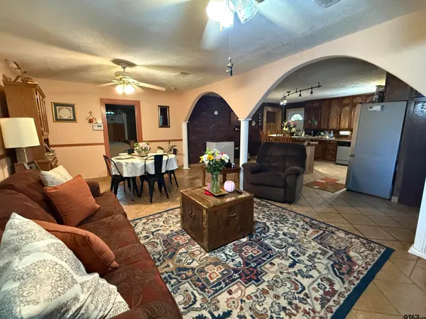 a living room with furniture and a chandelier