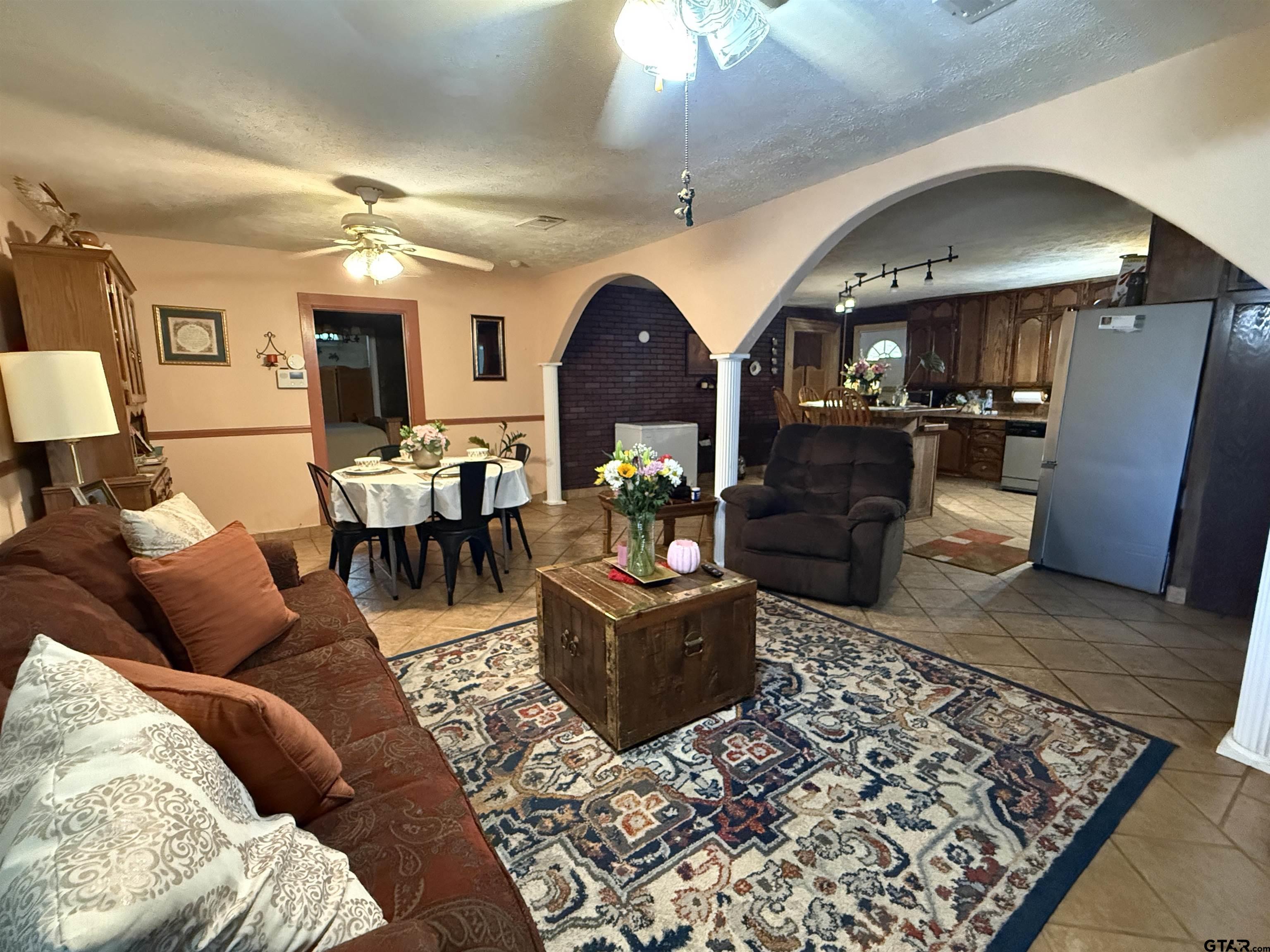 508 Whippoorwill Street Henderson, TX 75652 - Photo 6 of 24 a living room with furniture and a chandelier