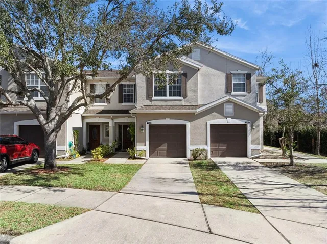 a view of house with yard in front of it
