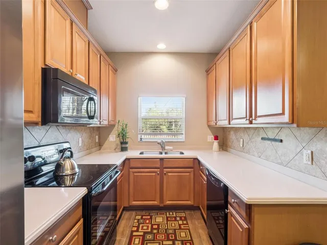 a kitchen that has a sink and a stove in it