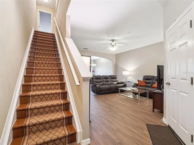 a view of a living room and entryway with furniture