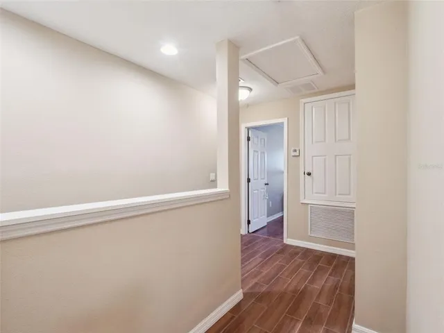 a view of empty room with wooden floor
