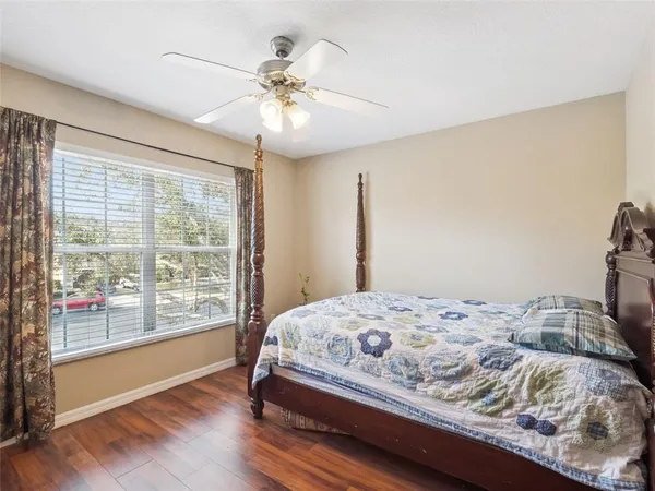 a bedroom with a large bed and a chandelier