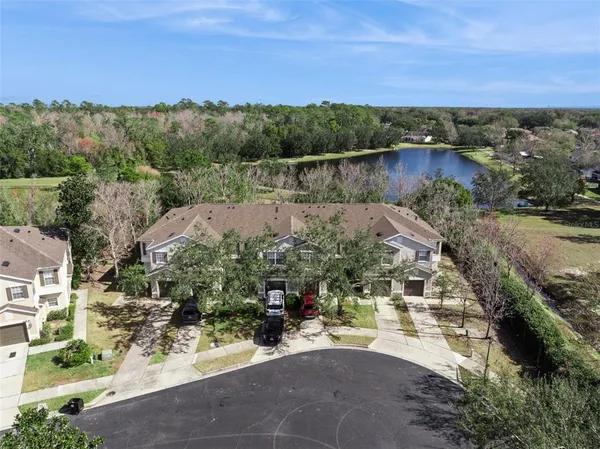 an aerial view of a house with a yard