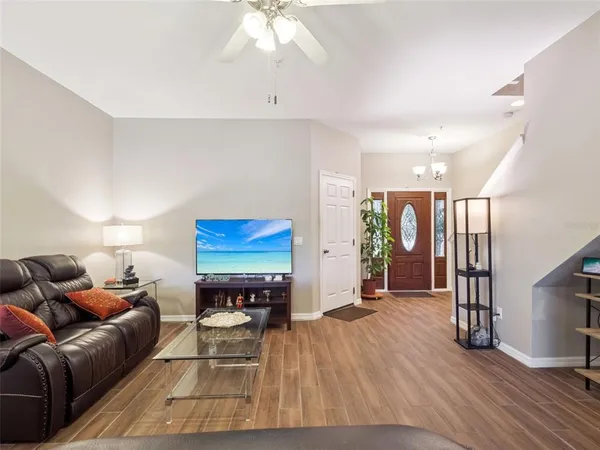 a living room with furniture and a wooden floor