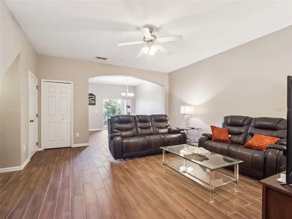 a living room with furniture and wooden floor