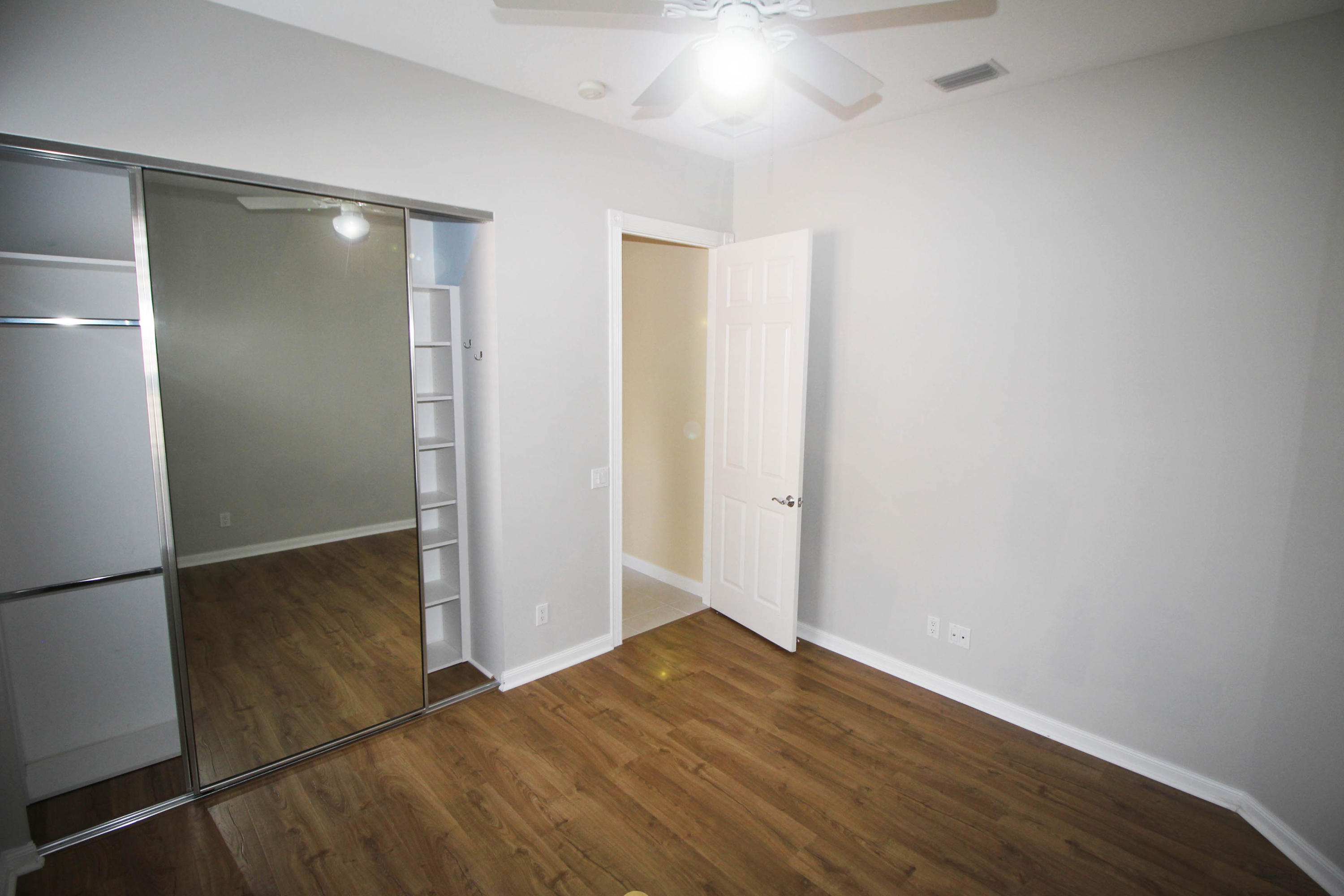 256 San Remo Drive Jupiter, FL 33458 - Photo 15 of 66 a view of empty room with wooden floor